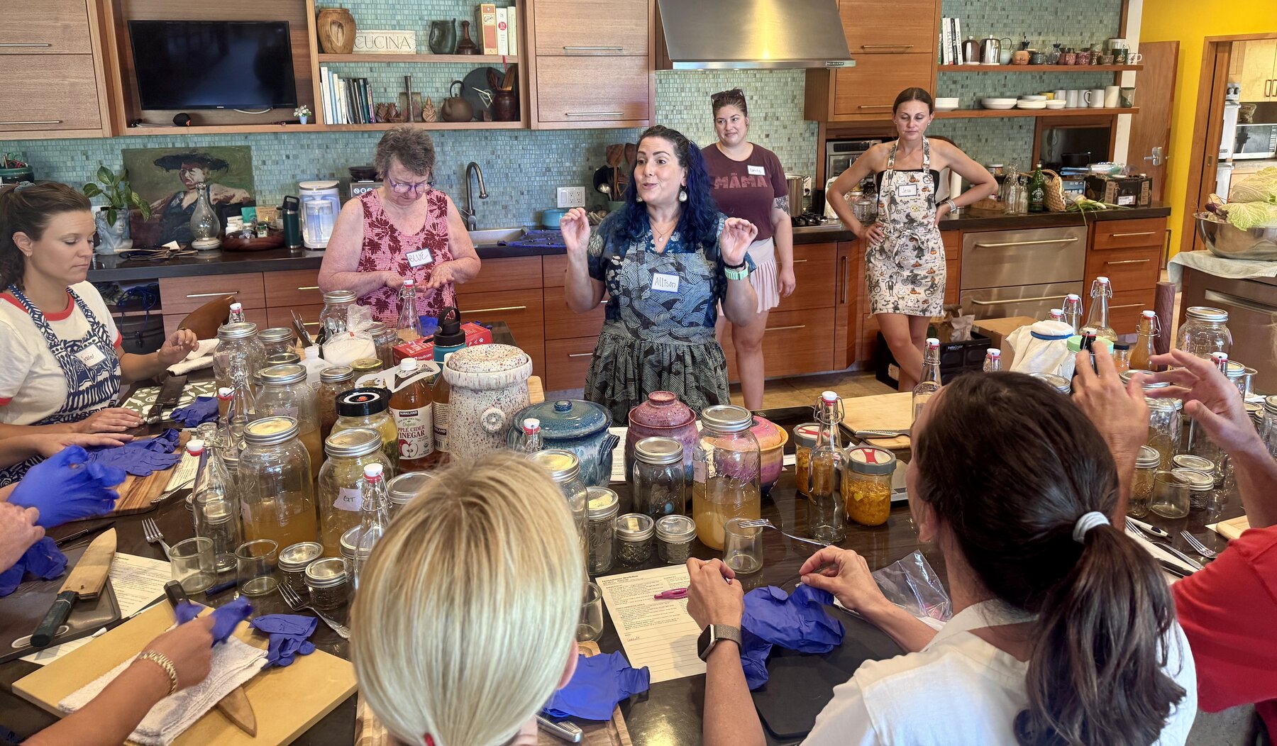 Allison Hardin teaching fermentation class participants around a table
