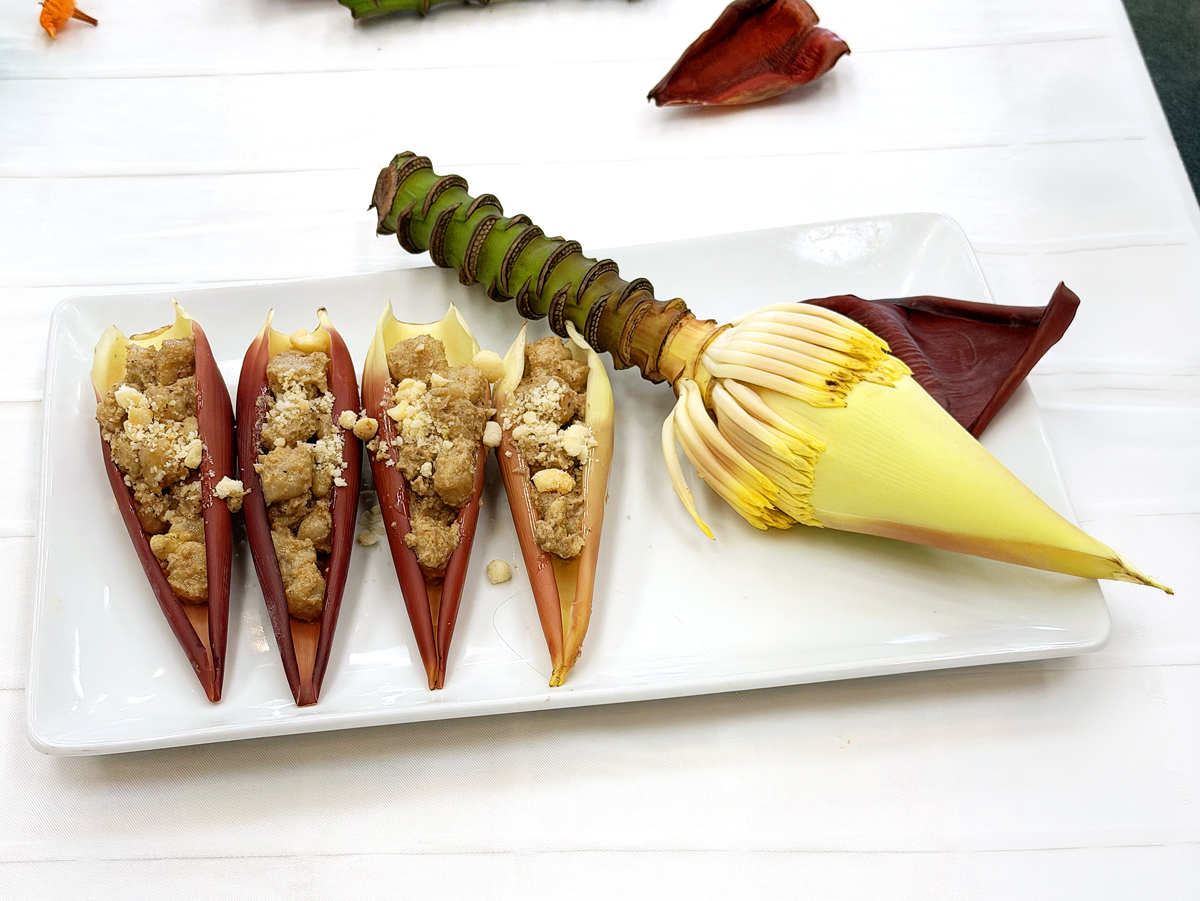 White plate with banana gnocchi and a banana flower for the judges at the cook-off
