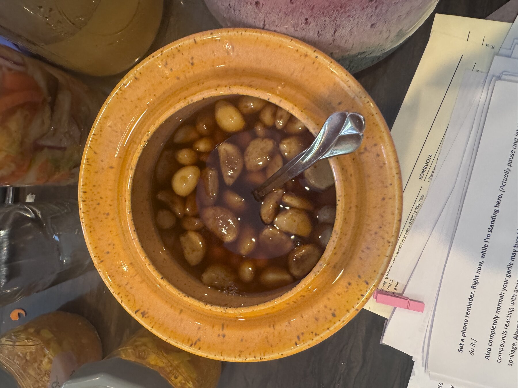 Garlic cloves submerged in honey for fermentation